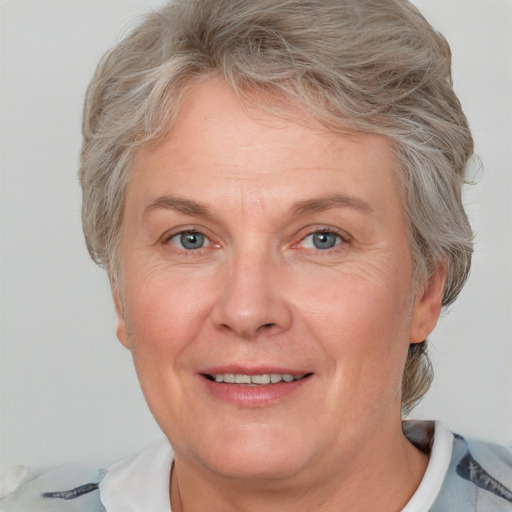 Joyful white middle-aged female with short  blond hair and grey eyes