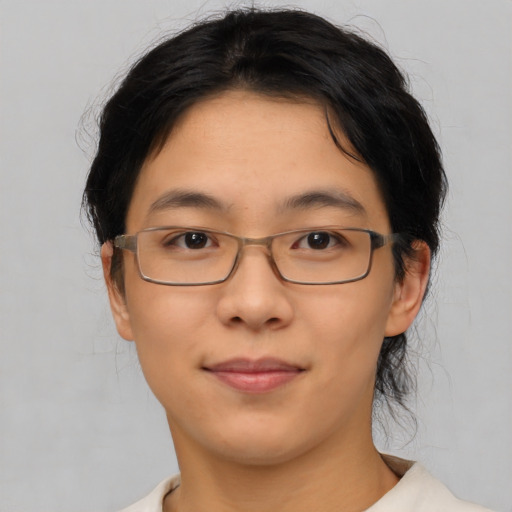 Joyful asian young-adult female with short  brown hair and brown eyes
