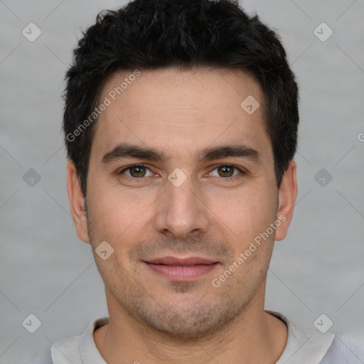 Joyful white young-adult male with short  black hair and brown eyes