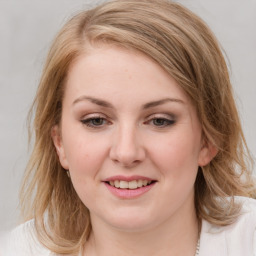 Joyful white young-adult female with medium  brown hair and blue eyes