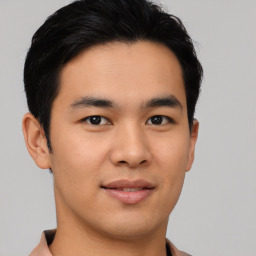 Joyful asian young-adult male with short  black hair and brown eyes