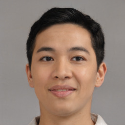 Joyful asian young-adult male with short  black hair and brown eyes