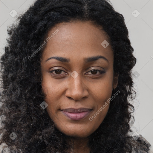 Joyful black young-adult female with long  brown hair and brown eyes