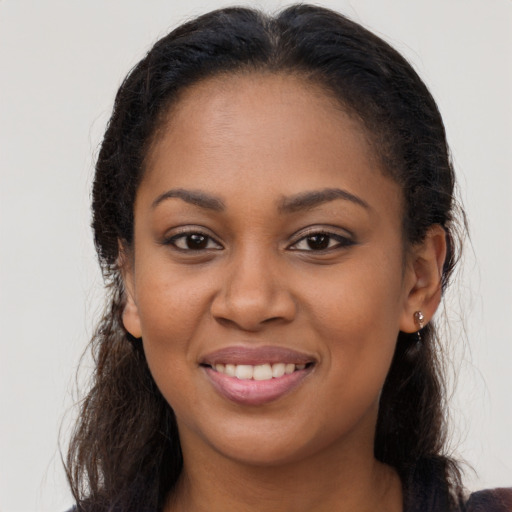 Joyful latino young-adult female with long  brown hair and brown eyes