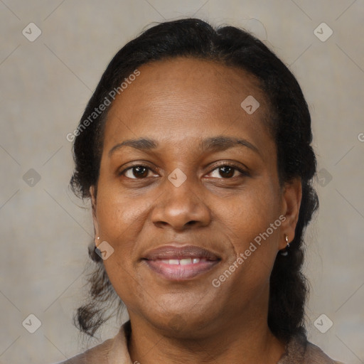 Joyful black adult female with medium  brown hair and brown eyes