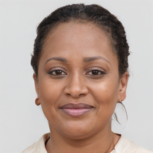 Joyful black adult female with short  brown hair and brown eyes