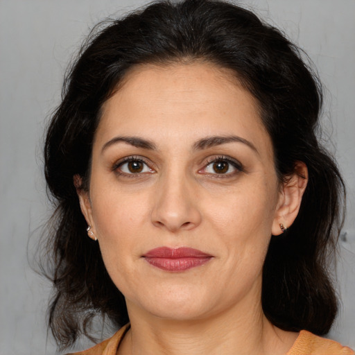 Joyful white adult female with medium  brown hair and brown eyes