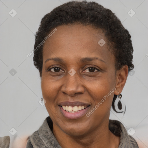 Joyful latino adult female with short  brown hair and brown eyes