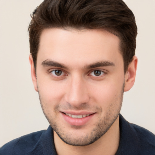 Joyful white young-adult male with short  brown hair and brown eyes