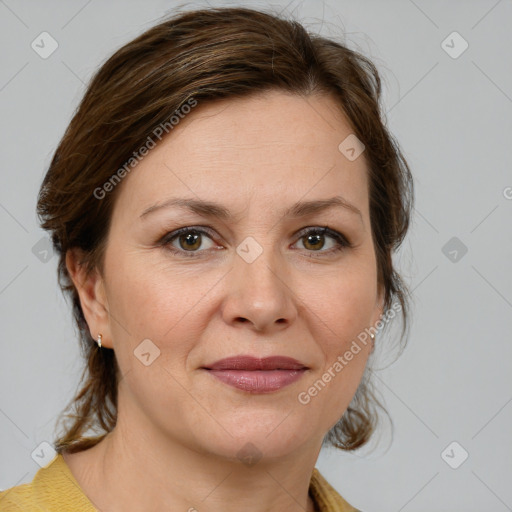 Joyful white adult female with medium  brown hair and green eyes