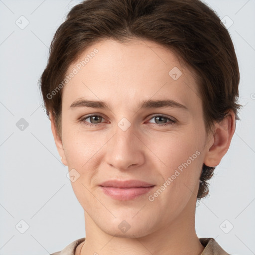 Joyful white young-adult female with short  brown hair and grey eyes