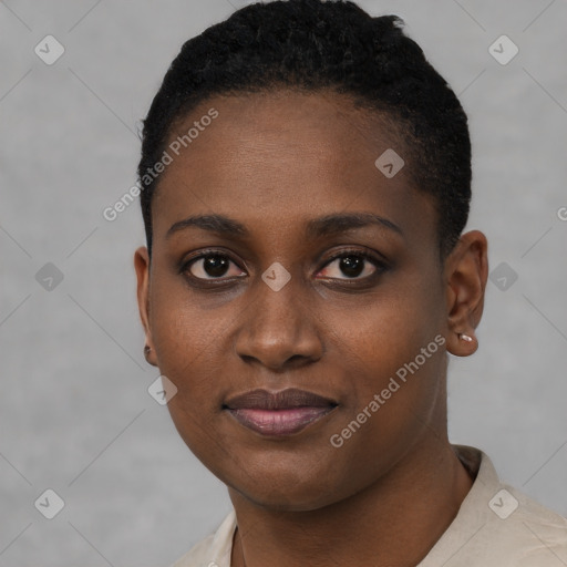 Joyful black young-adult female with short  black hair and brown eyes