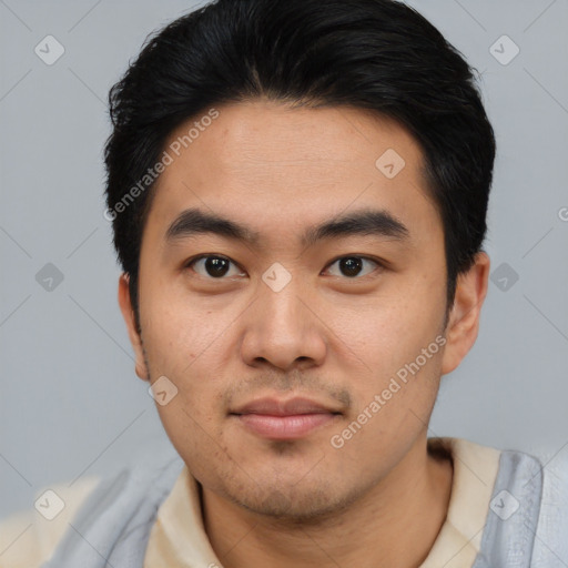 Joyful asian young-adult male with short  black hair and brown eyes