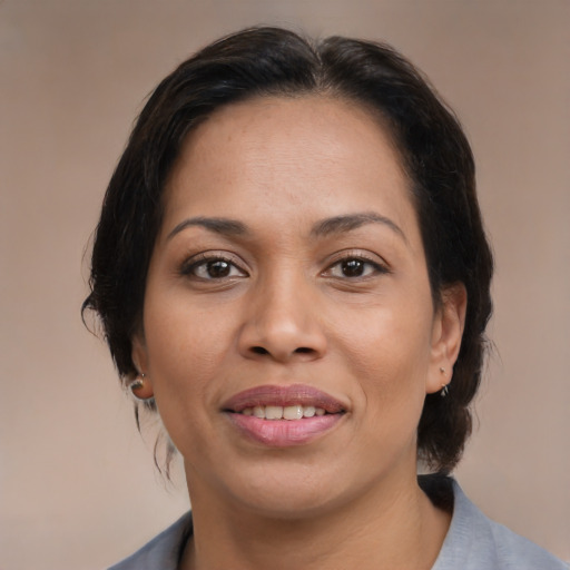 Joyful black young-adult female with medium  brown hair and brown eyes