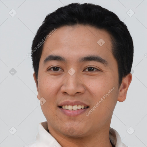 Joyful asian young-adult male with short  black hair and brown eyes