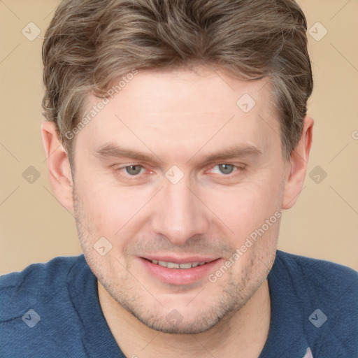 Joyful white adult male with short  brown hair and grey eyes