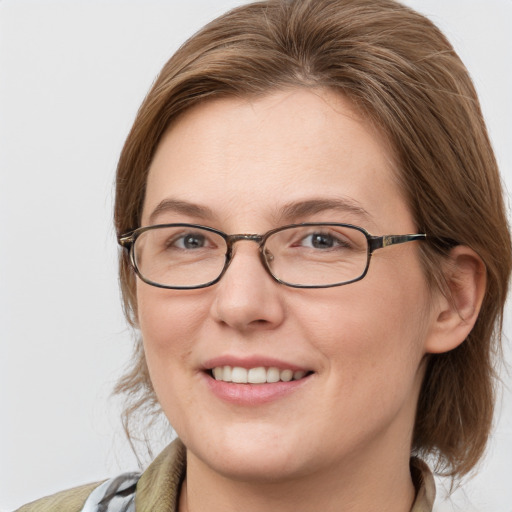 Joyful white young-adult female with medium  brown hair and blue eyes