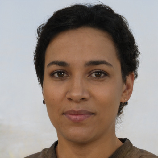 Joyful latino young-adult female with short  brown hair and brown eyes