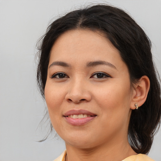 Joyful asian young-adult female with medium  brown hair and brown eyes