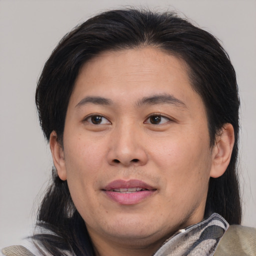 Joyful asian young-adult male with medium  brown hair and brown eyes