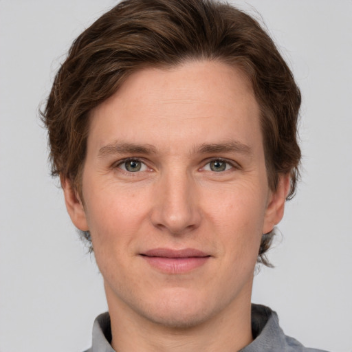 Joyful white adult male with short  brown hair and grey eyes