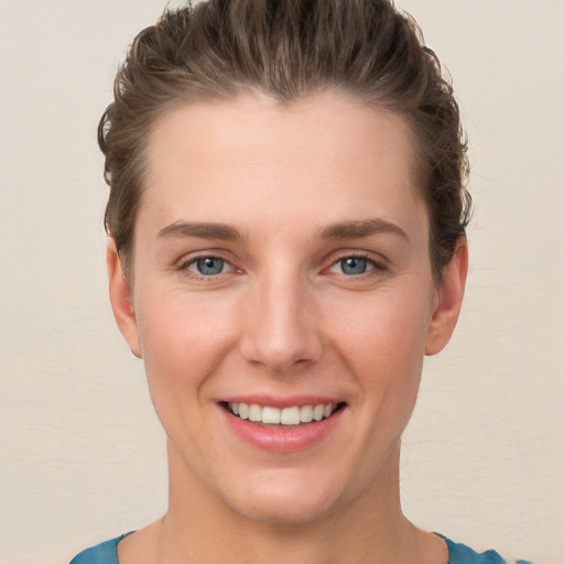 Joyful white young-adult female with short  brown hair and grey eyes