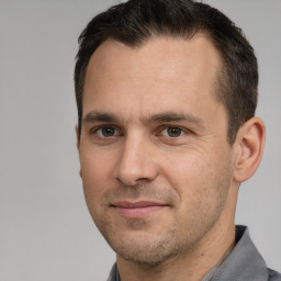 Joyful white adult male with short  brown hair and brown eyes