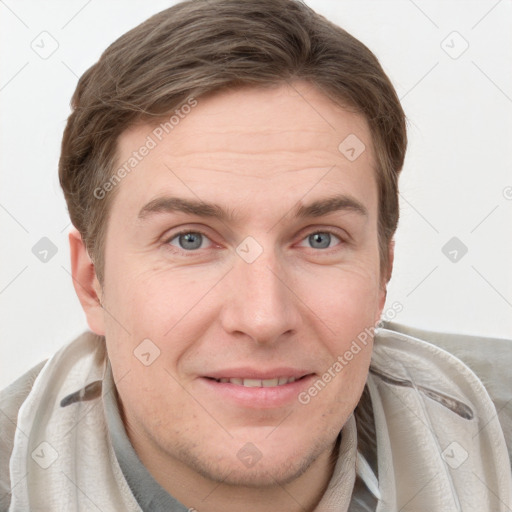 Joyful white young-adult male with short  brown hair and grey eyes