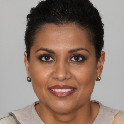 Joyful black young-adult female with short  brown hair and brown eyes