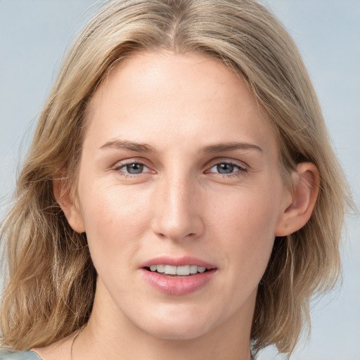 Joyful white young-adult female with medium  brown hair and blue eyes