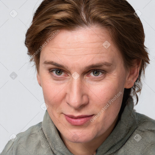 Joyful white adult female with medium  brown hair and blue eyes