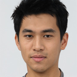 Joyful asian young-adult male with short  black hair and brown eyes