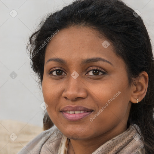 Joyful black young-adult female with long  brown hair and brown eyes