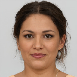 Joyful white young-adult female with medium  brown hair and brown eyes