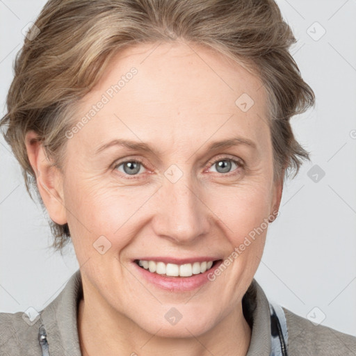 Joyful white adult female with medium  brown hair and blue eyes