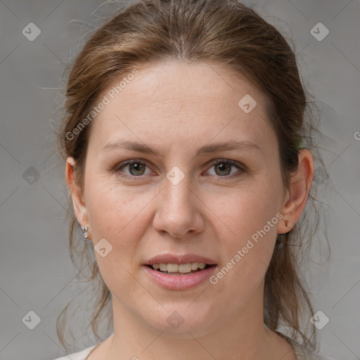 Joyful white young-adult female with medium  brown hair and grey eyes