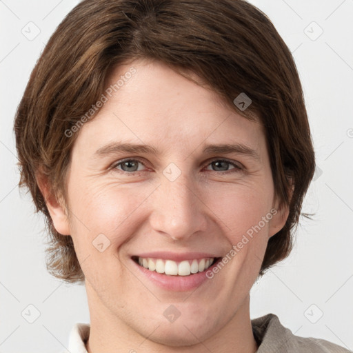 Joyful white young-adult female with short  brown hair and grey eyes