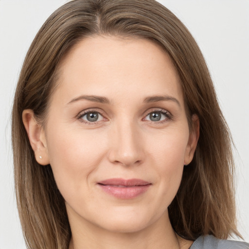 Joyful white young-adult female with long  brown hair and grey eyes