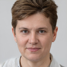 Joyful white adult male with short  brown hair and grey eyes