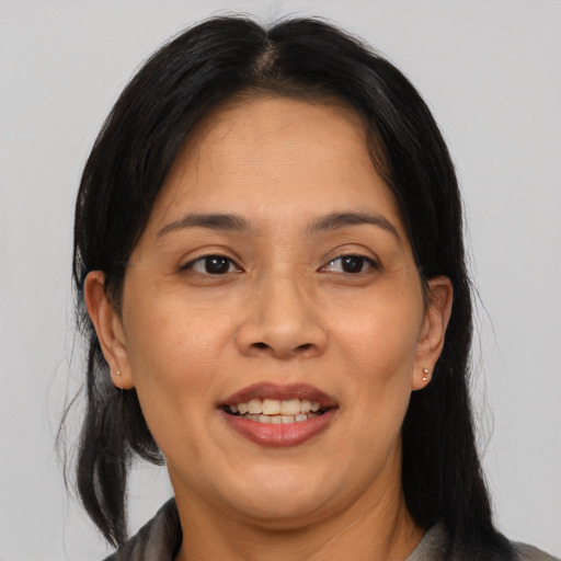Joyful asian adult female with medium  brown hair and brown eyes