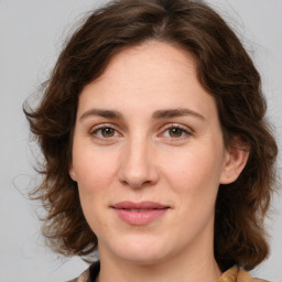 Joyful white young-adult female with medium  brown hair and green eyes