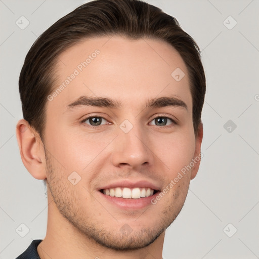 Joyful white young-adult male with short  brown hair and grey eyes