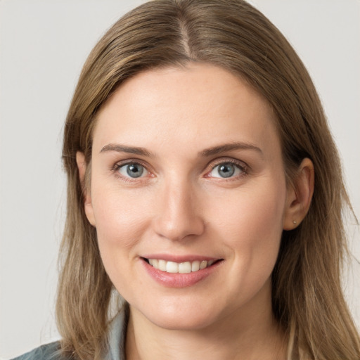 Joyful white young-adult female with long  brown hair and grey eyes