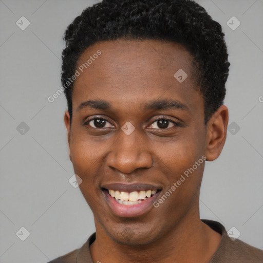 Joyful black young-adult male with short  brown hair and brown eyes