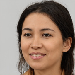 Joyful latino young-adult female with long  brown hair and brown eyes