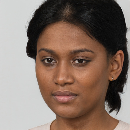 Neutral black young-adult female with medium  brown hair and brown eyes