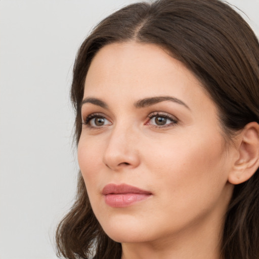 Neutral white young-adult female with long  brown hair and brown eyes