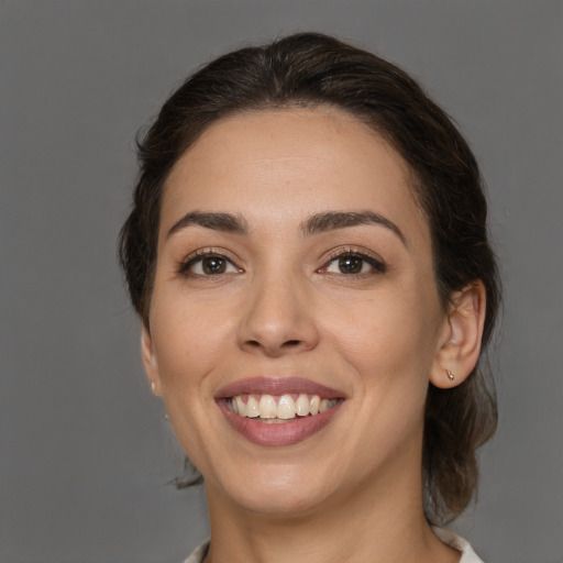 Joyful white young-adult female with medium  brown hair and brown eyes