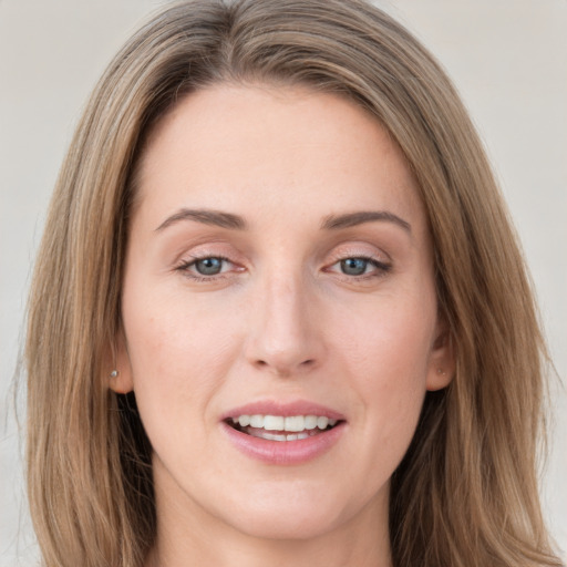 Joyful white young-adult female with long  brown hair and green eyes