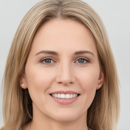 Joyful white young-adult female with long  brown hair and green eyes